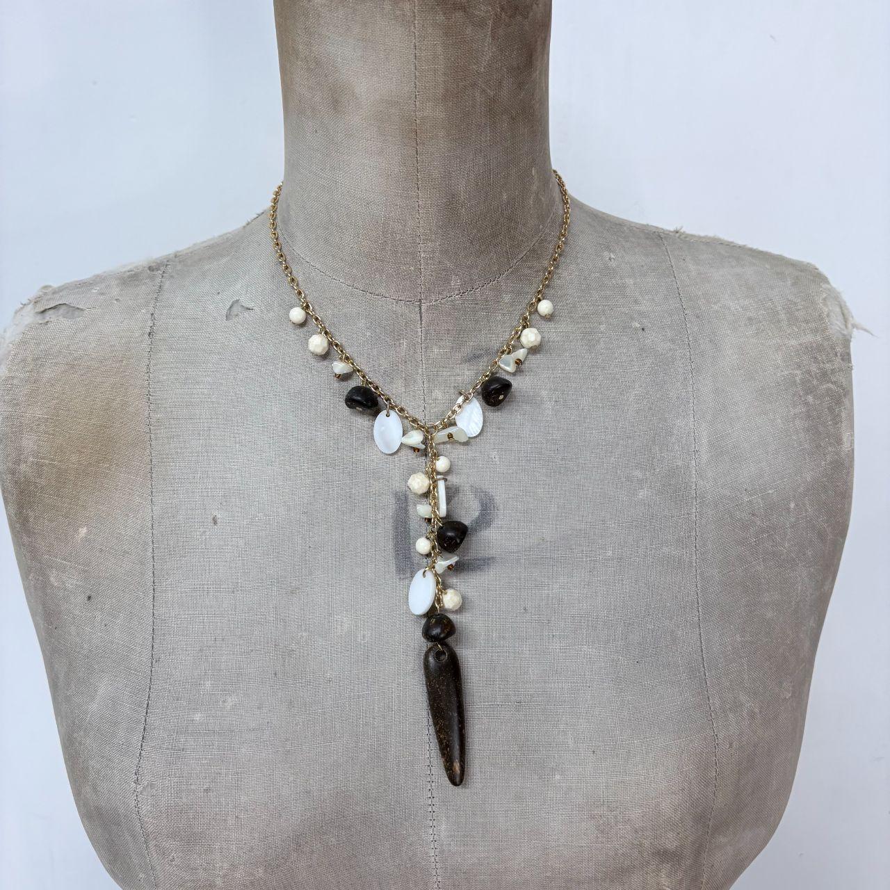 Gold chain draped mother of pearl necklace