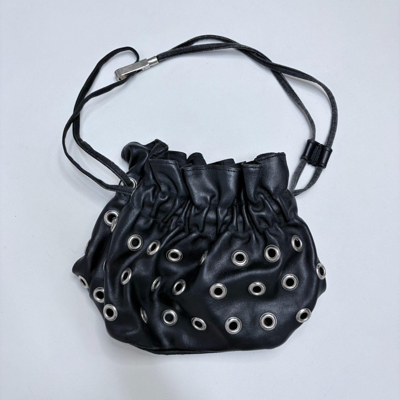 Black eyelet studded cinch bag