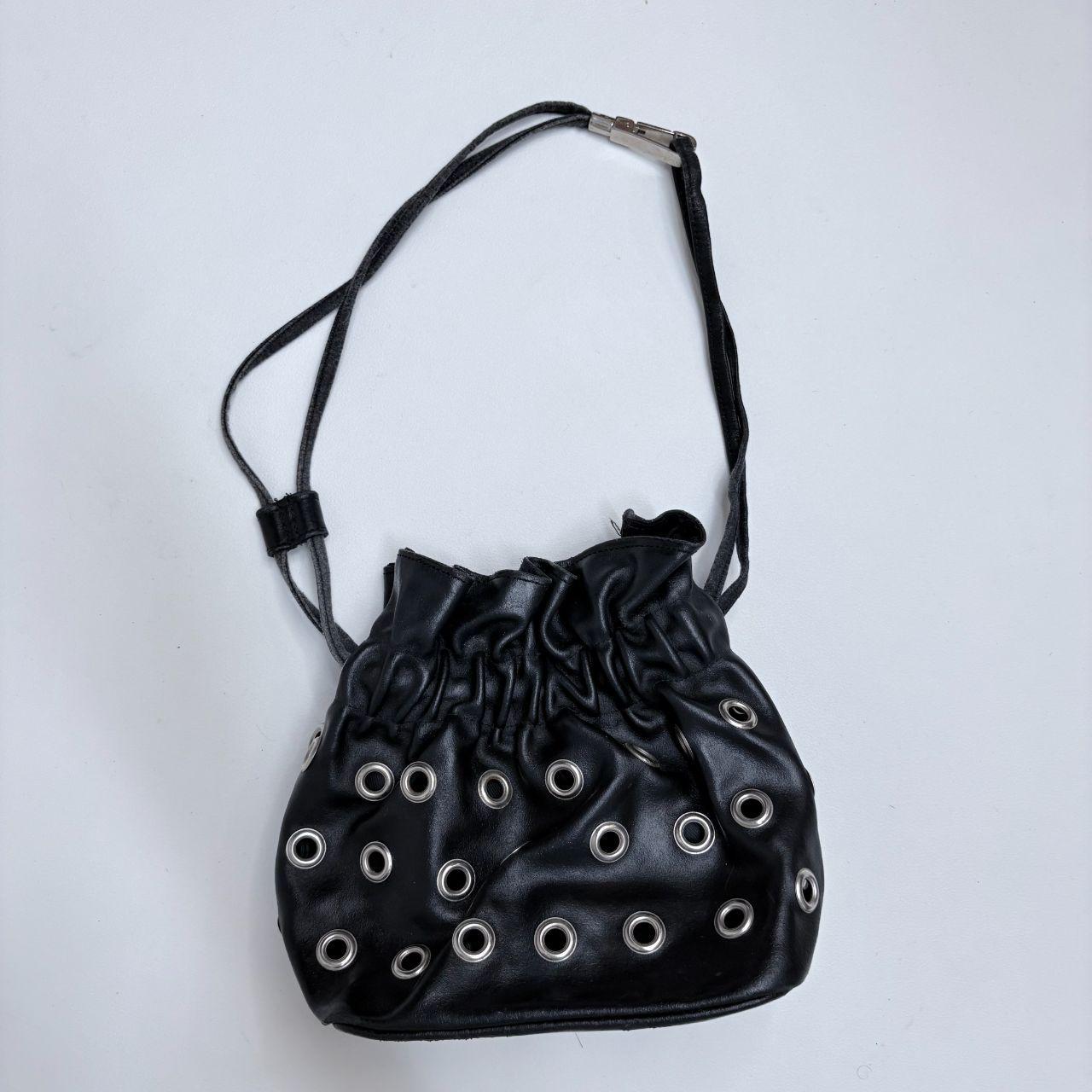 Black eyelet studded cinch bag