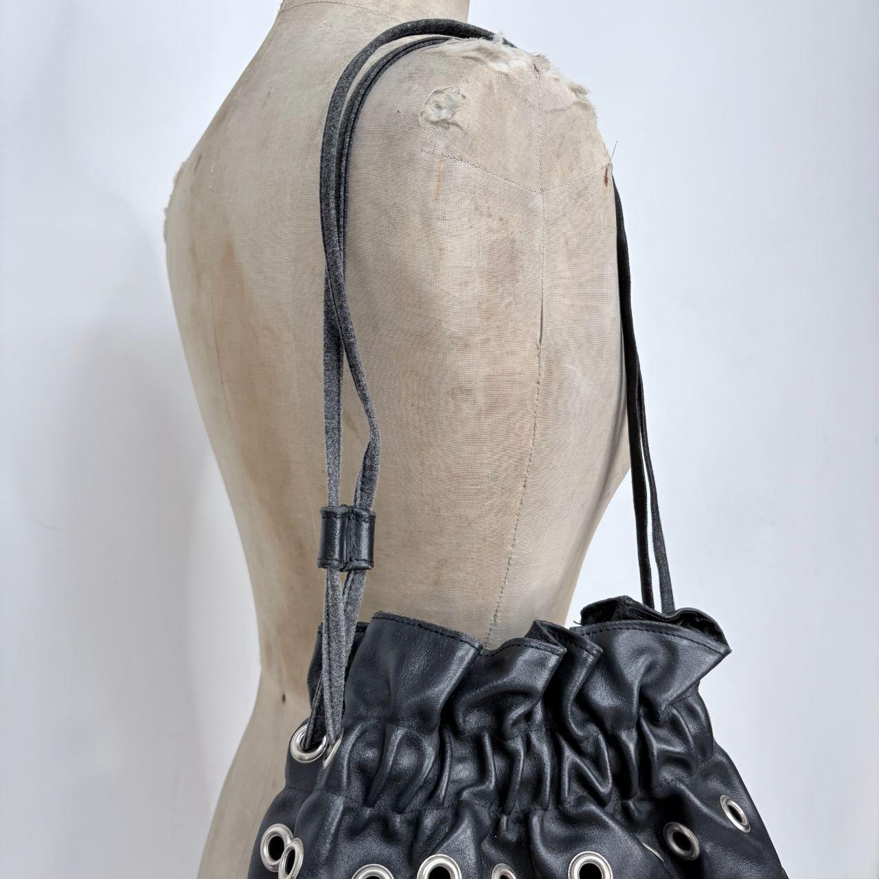 Black eyelet studded cinch bag