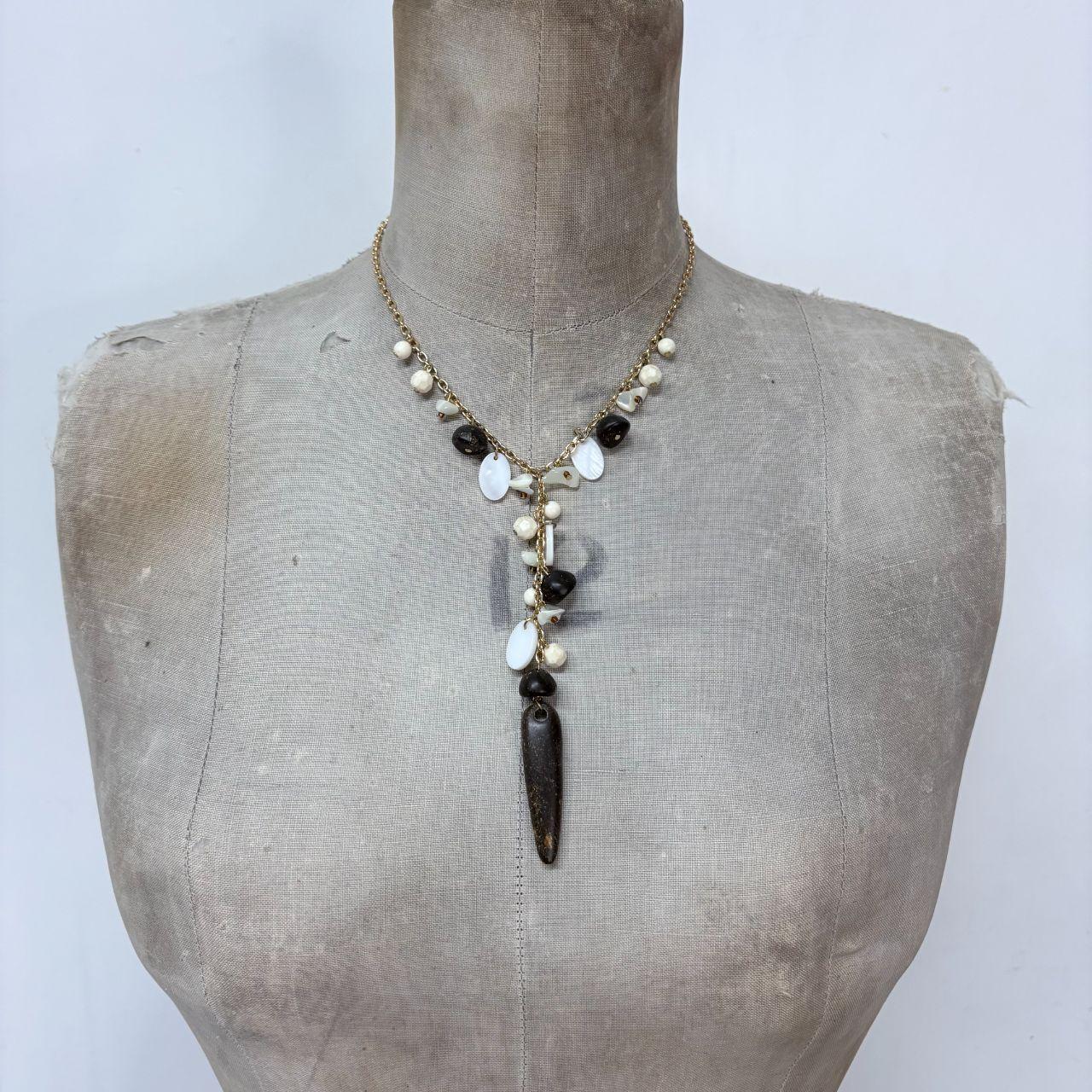 Gold chain draped mother of pearl necklace