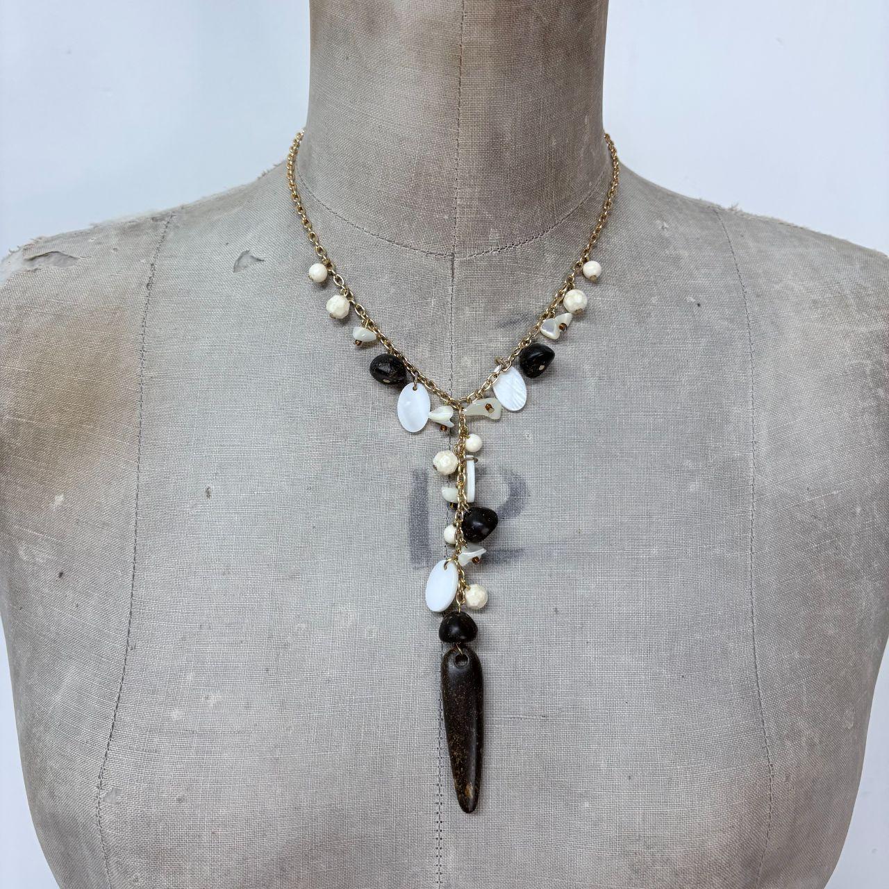 Gold chain draped mother of pearl necklace