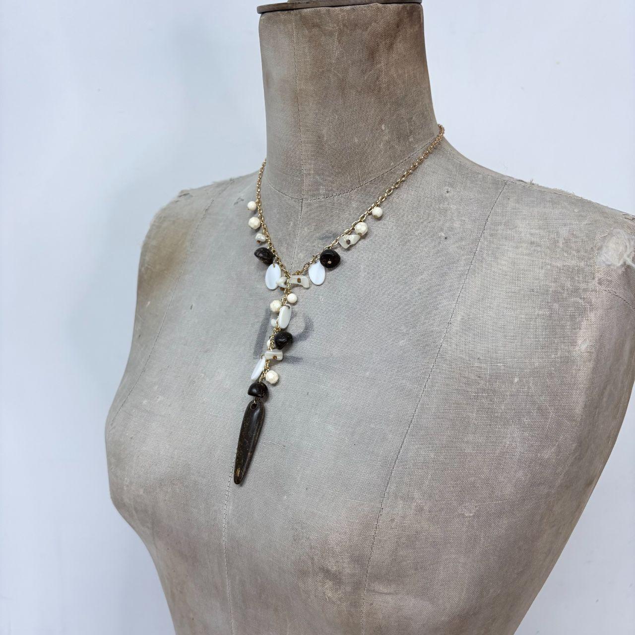 Gold chain draped mother of pearl necklace