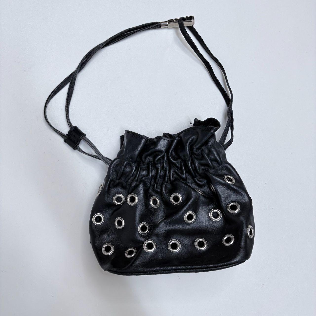 Black eyelet studded cinch bag
