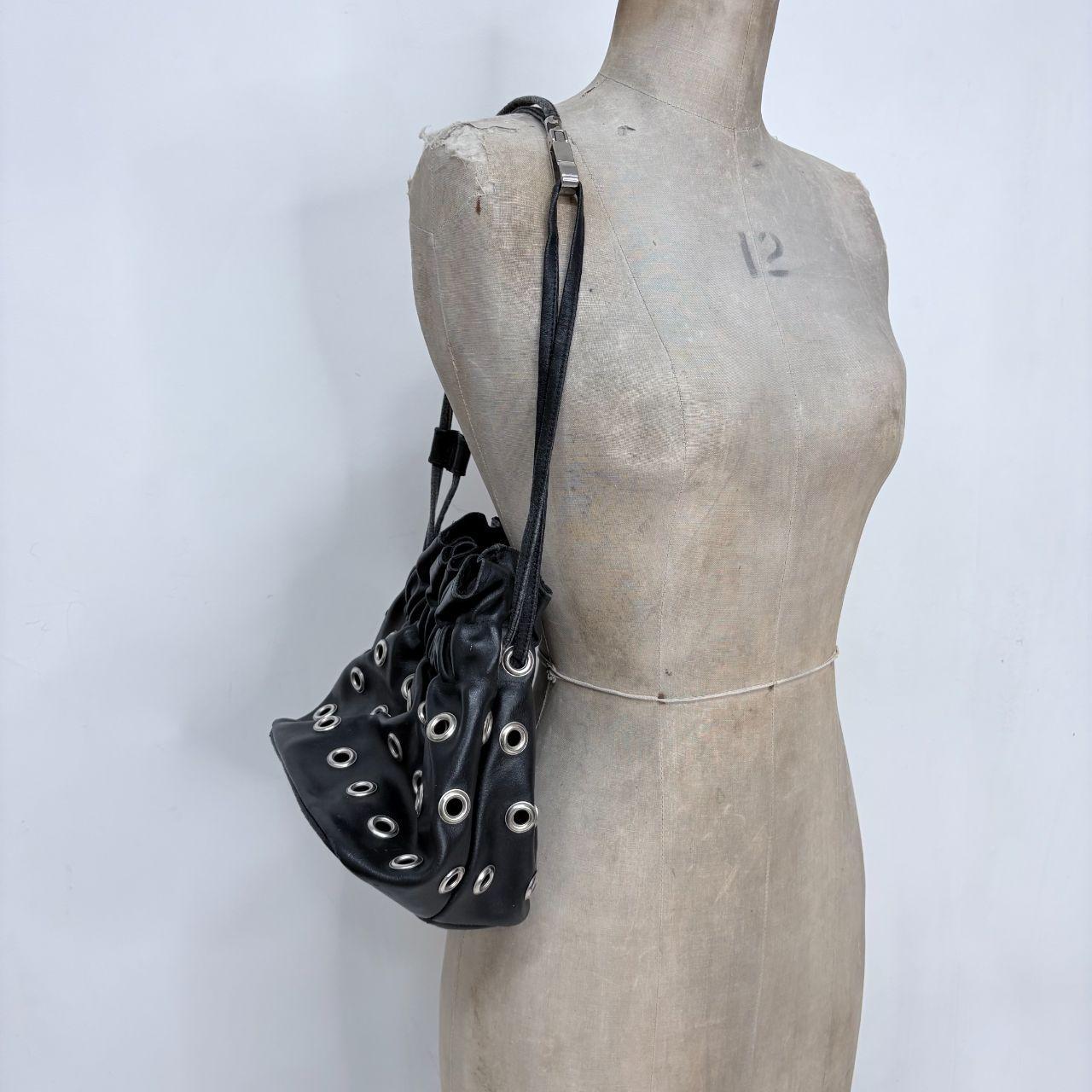 Black eyelet studded cinch bag