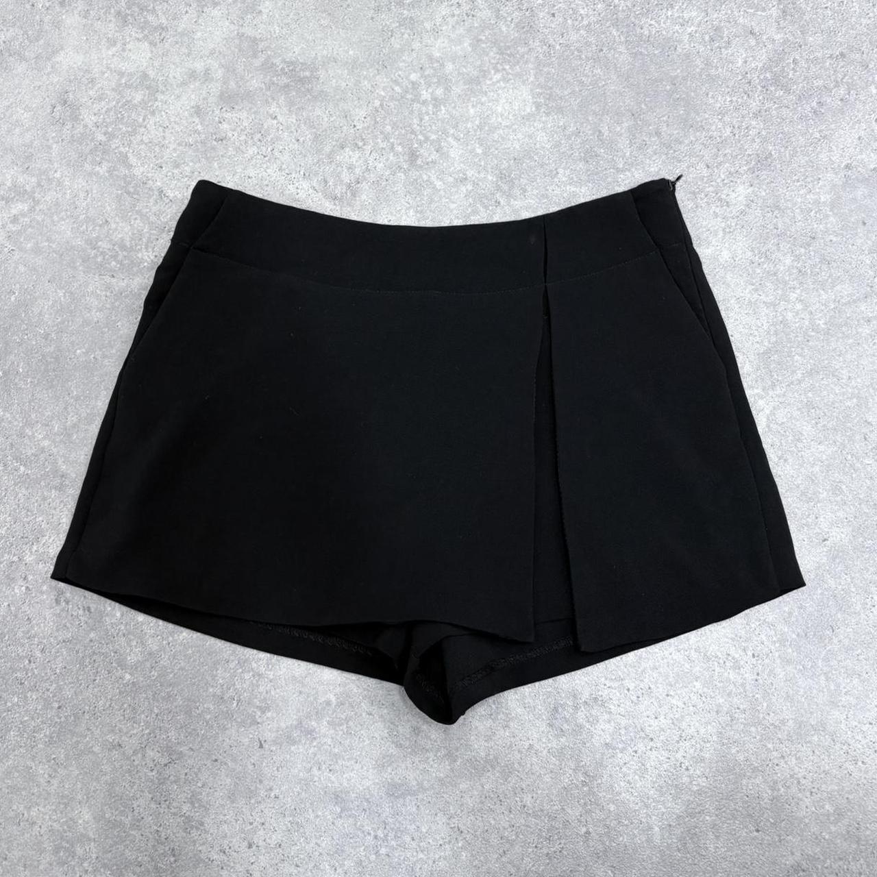 Black asymmetrical slit pleat mini skort