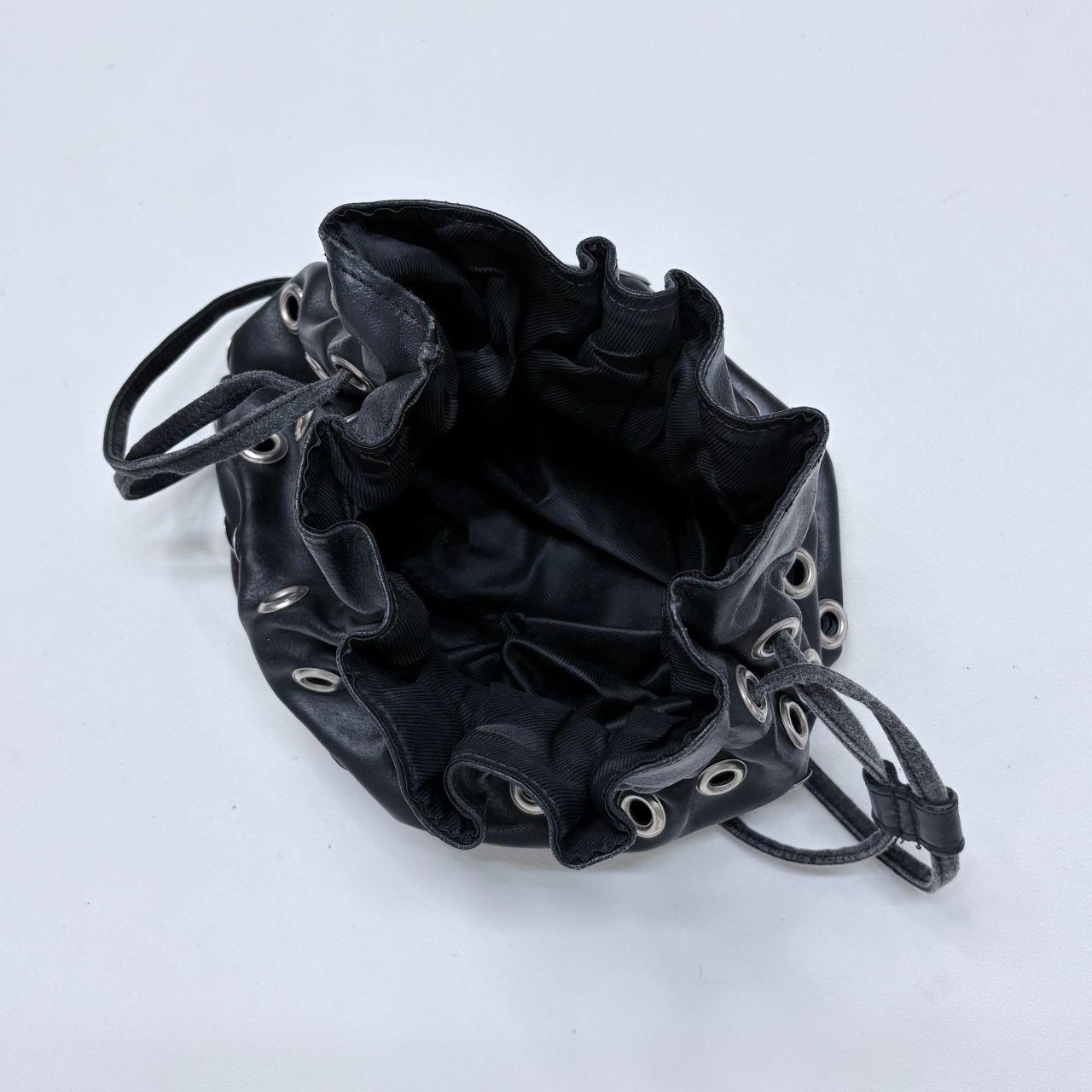 Black eyelet studded cinch bag