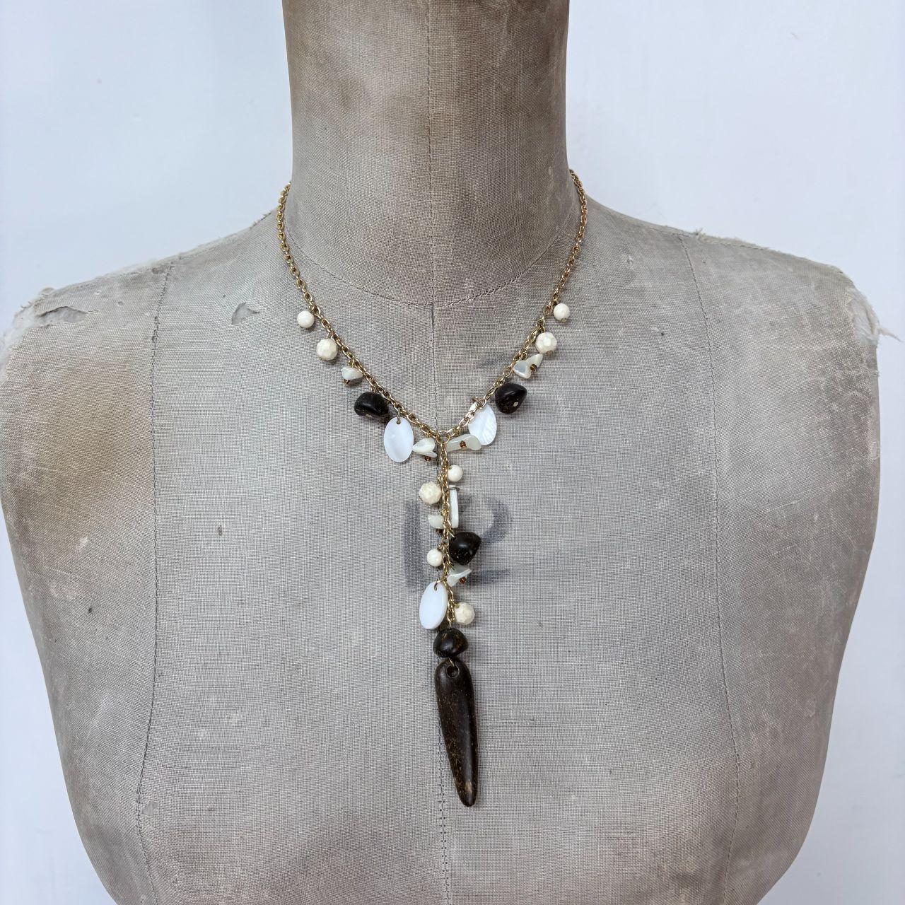 Gold chain draped mother of pearl necklace