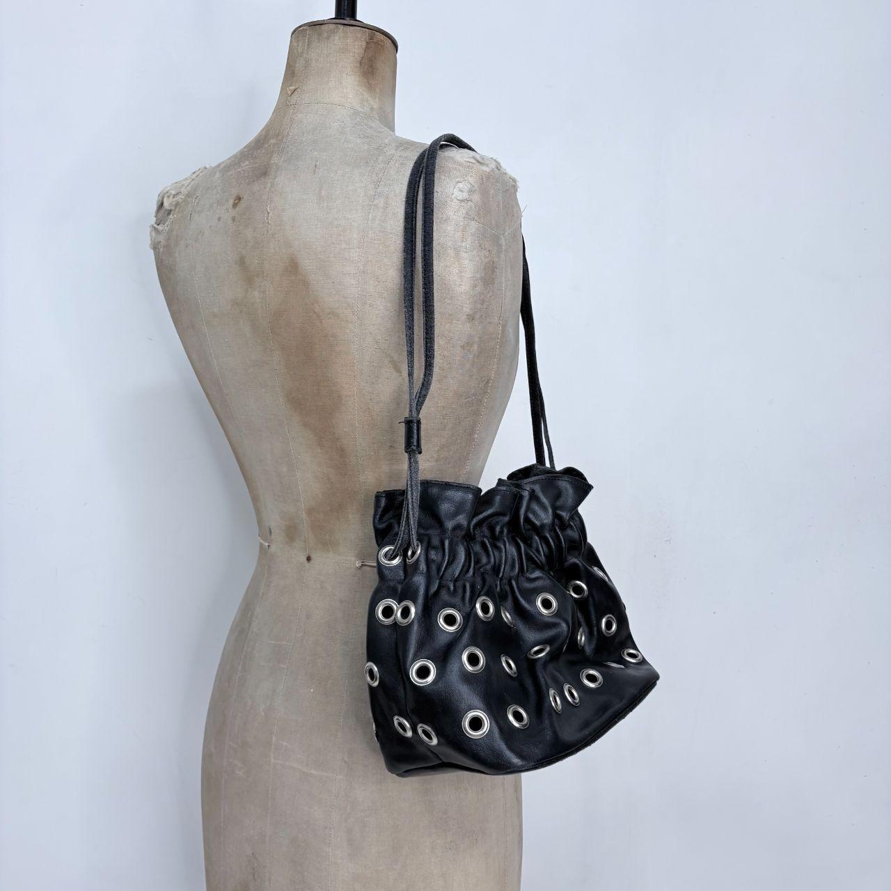 Black eyelet studded cinch bag