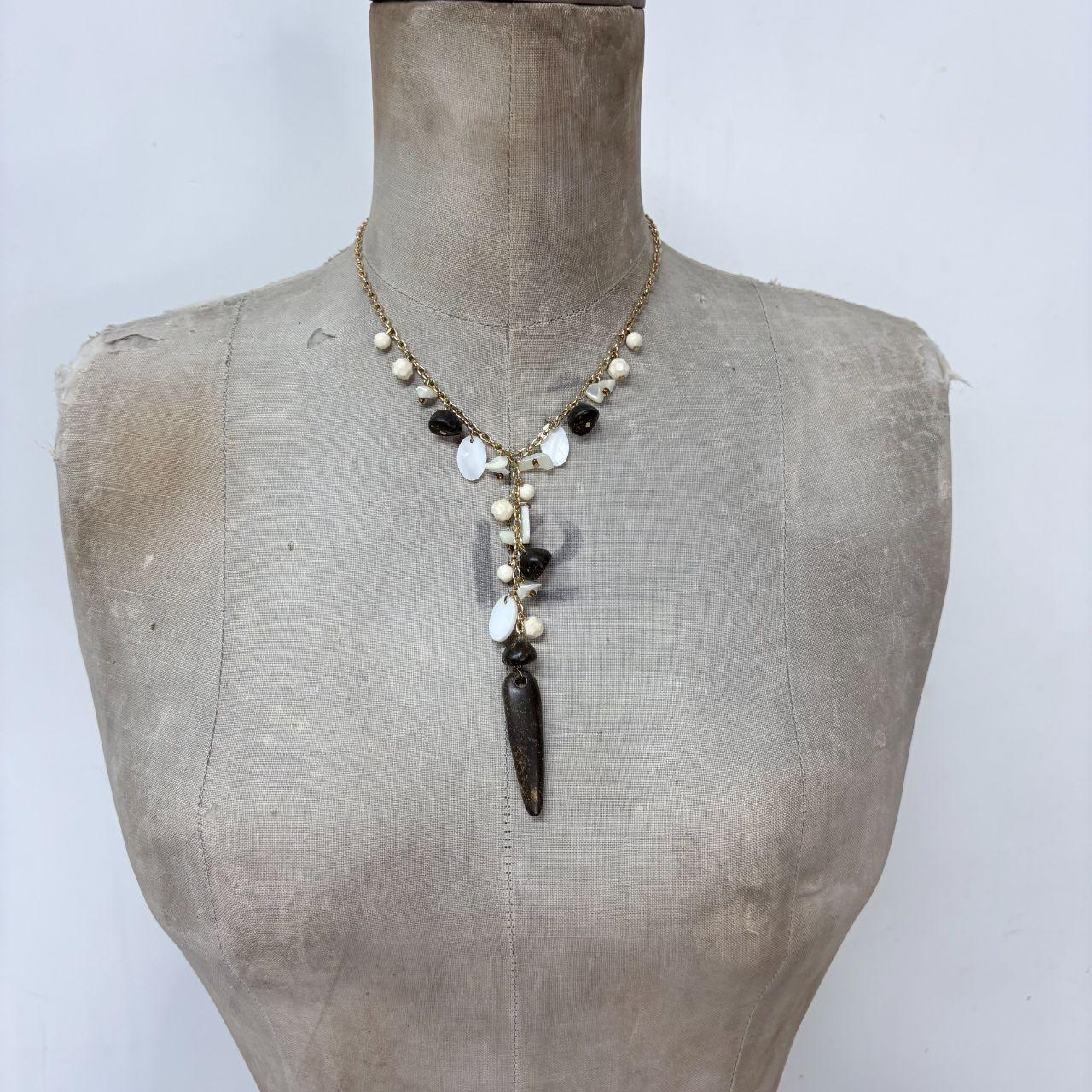 Gold chain draped mother of pearl necklace