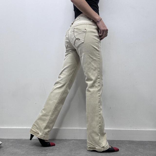 Cream flared distressed trousers