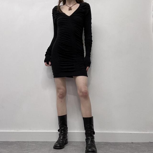 Black cinched long sleeve knit dress