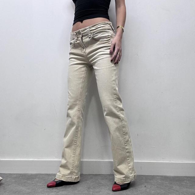 Cream flared distressed trousers