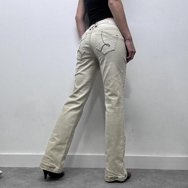 Cream flared distressed trousers