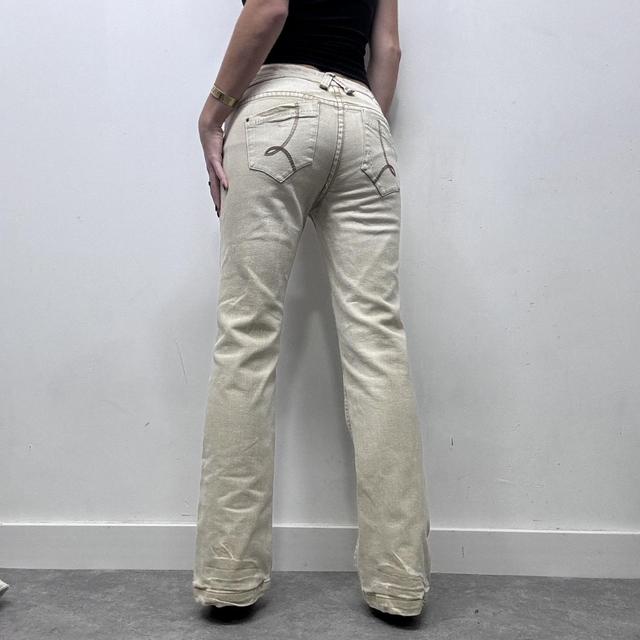 Cream flared distressed trousers