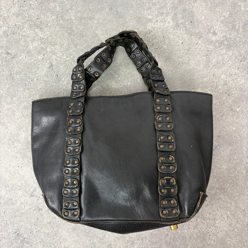 Black mini handbag with studded patchwork handle.