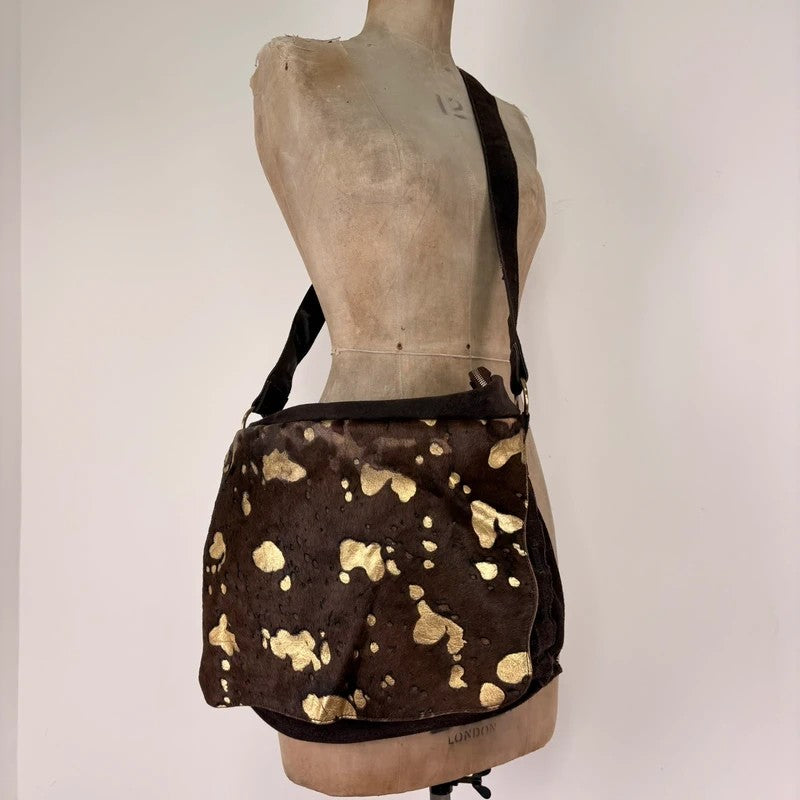 Brown cow hide leather satchel bag with gold embellishment