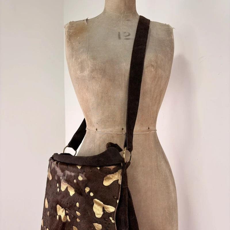 Brown cow hide leather satchel bag with gold embellishment