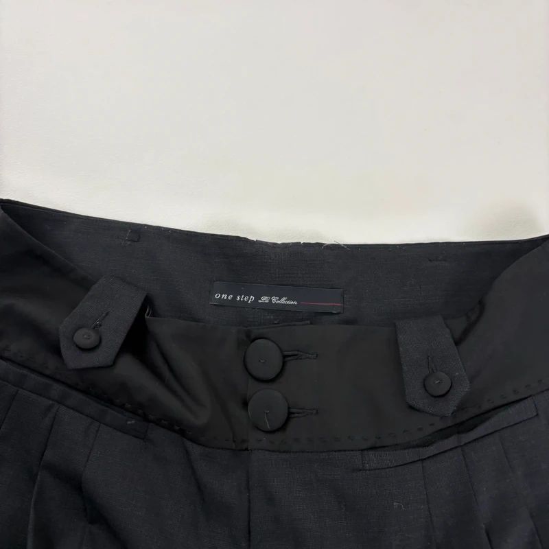 pleated black tailored trousers