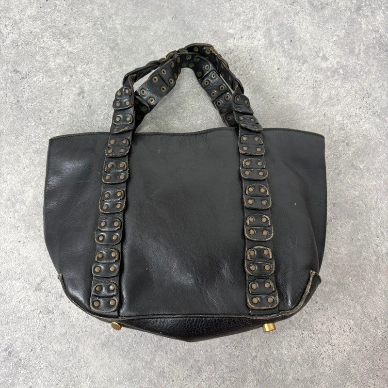 Black mini handbag with studded patchwork handle.