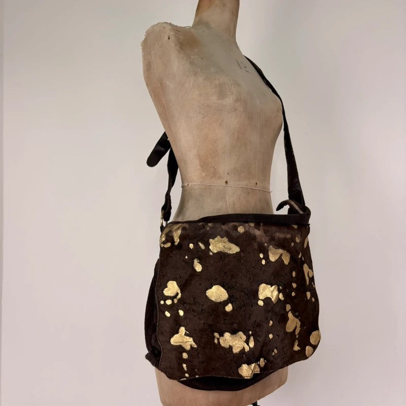 Brown cow hide leather satchel bag with gold embellishment