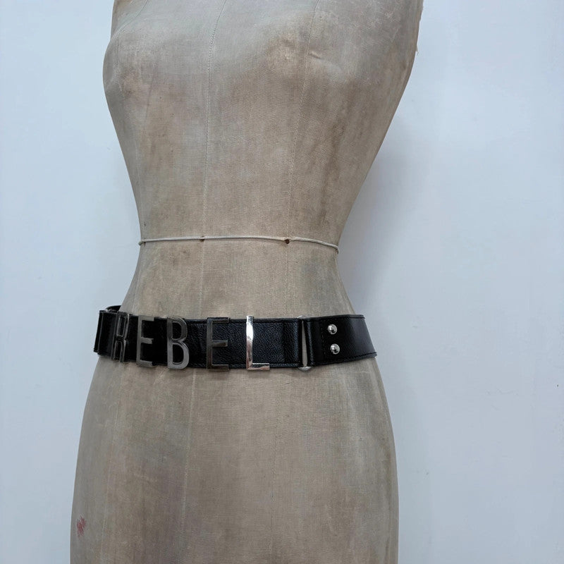 black faux leather silver spellout belt