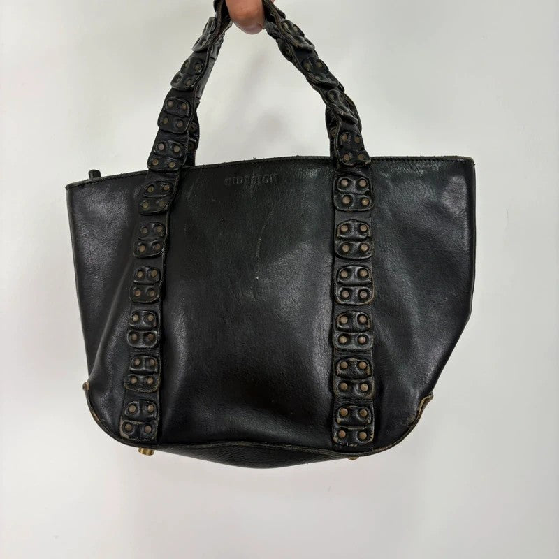 Black mini handbag with studded patchwork handle.