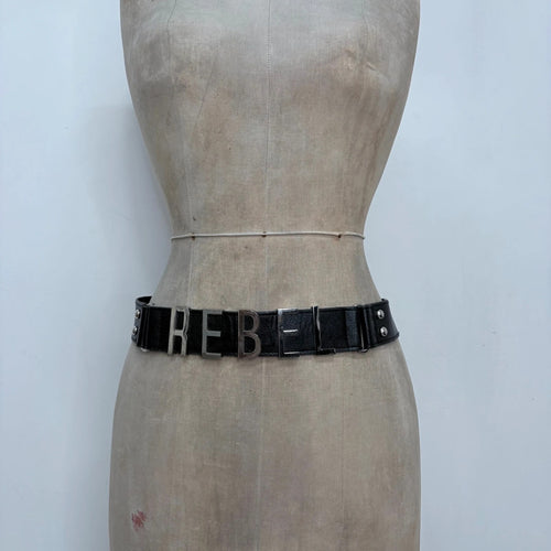 black faux leather silver spellout belt