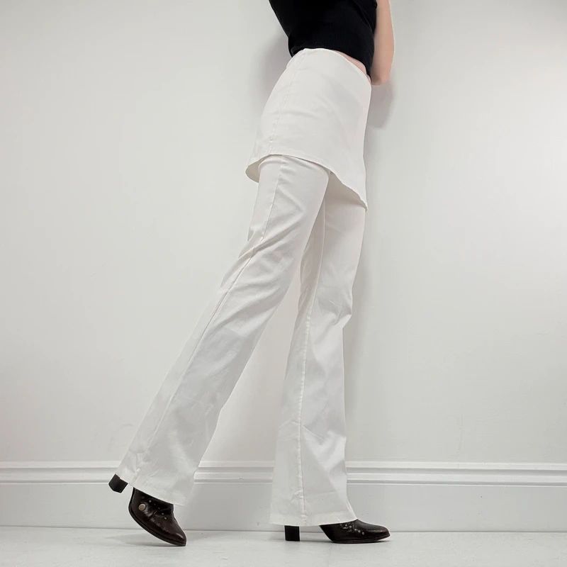Layered flared trousers with mini skirt overlay