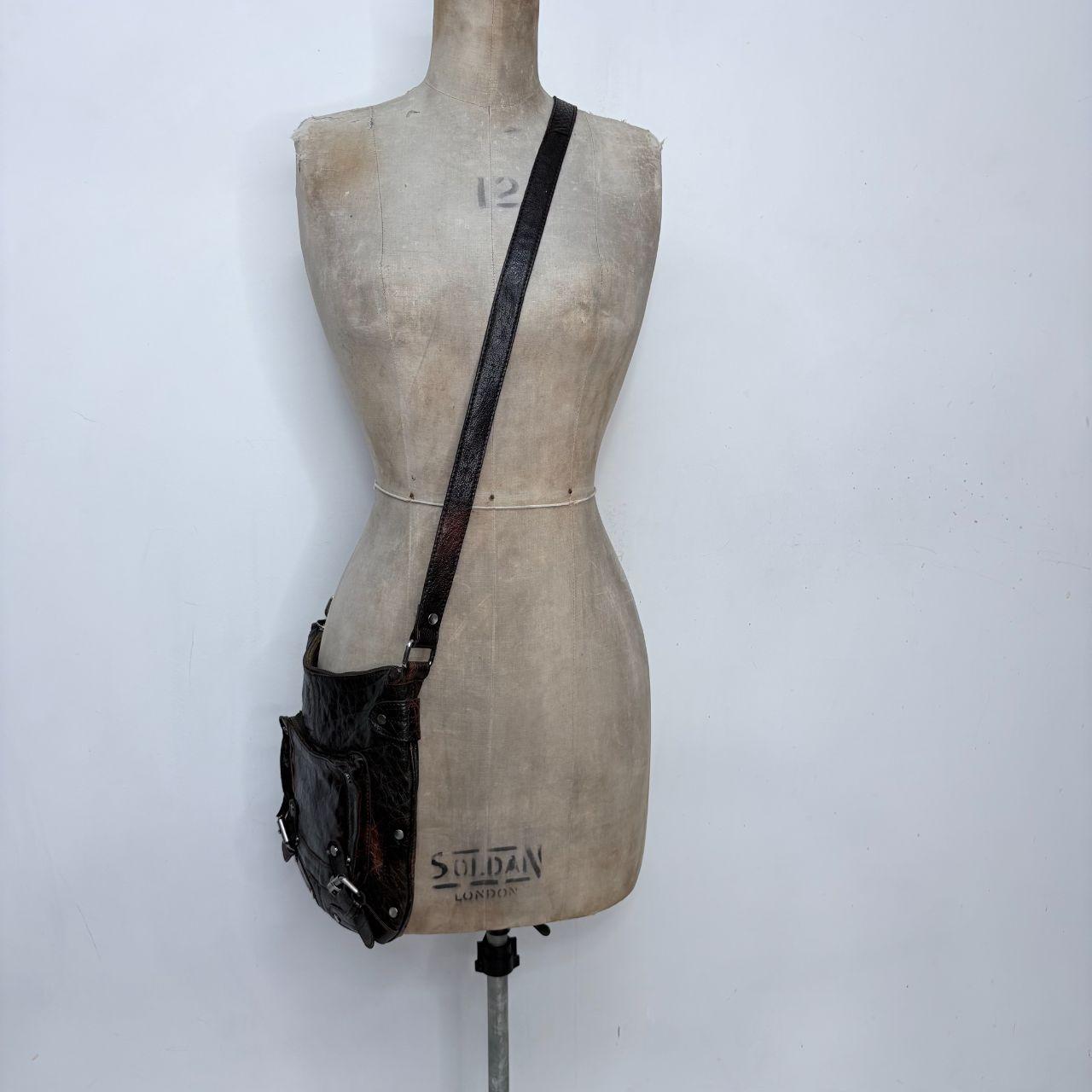 Distressed brown leather buckle studded bag