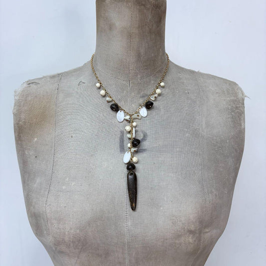 Gold chain draped mother of pearl necklace