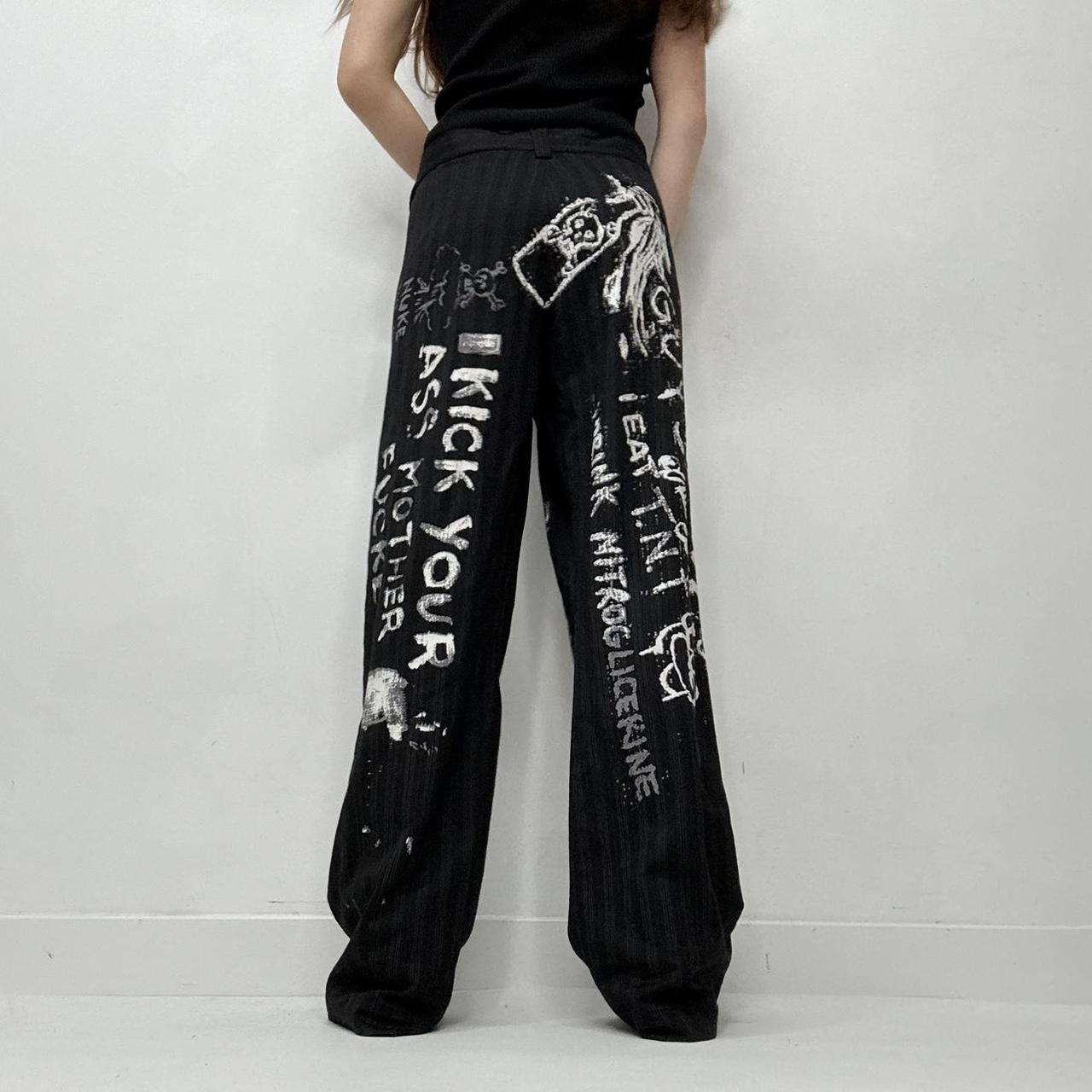 Black pinstripe graphic text trousers