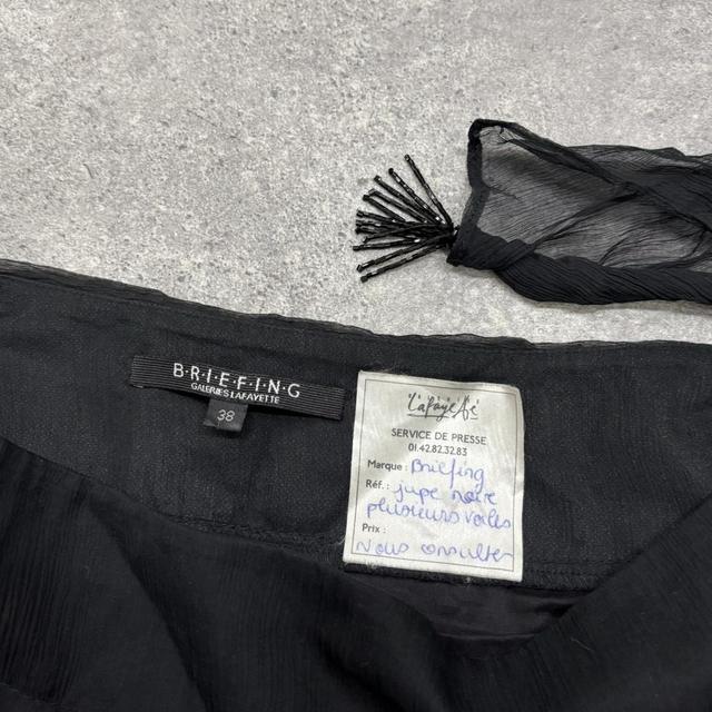 Sheer black asymmetric flutter skirt
