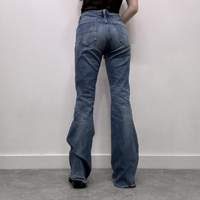 Flared distressed denim jeans