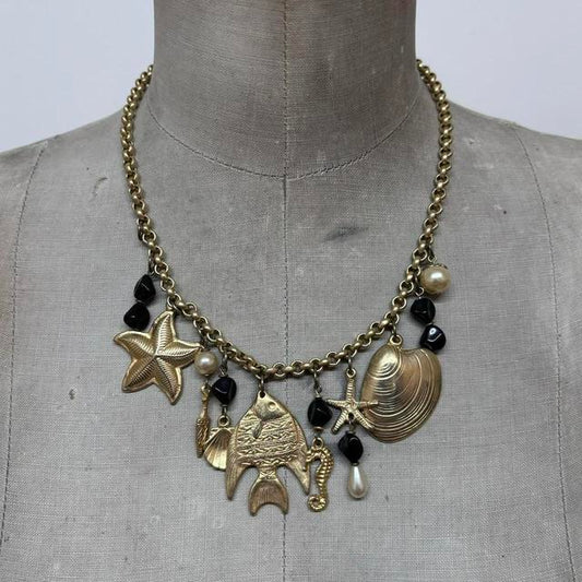 Gold sea shell mermaid charm necklace