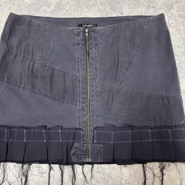 Distressed grunge pleated denim mini skirt