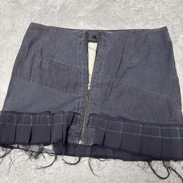 Distressed grunge pleated denim mini skirt