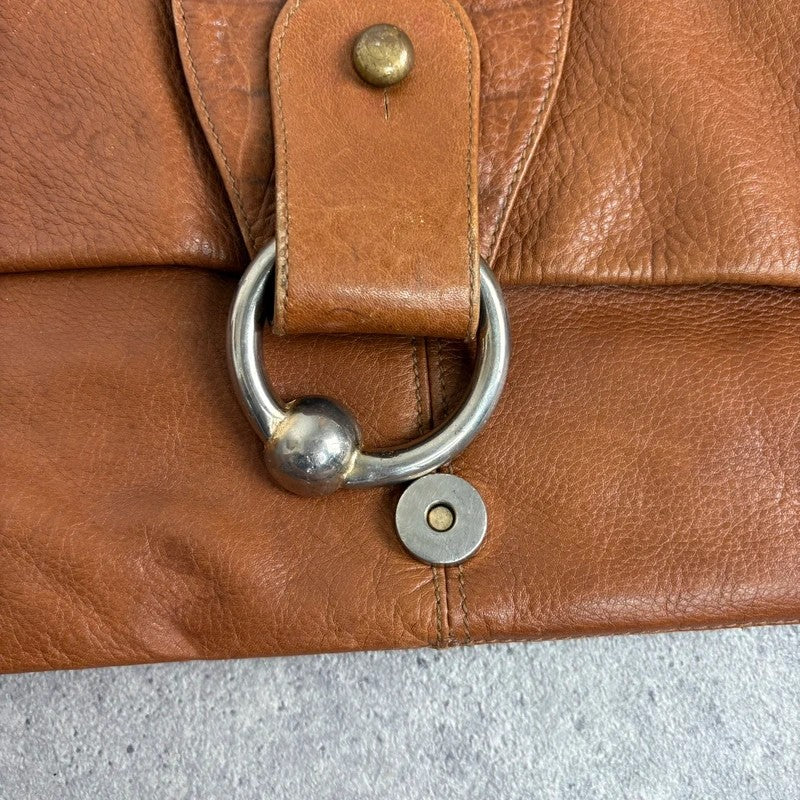 tan lather piercing punky silver hardware clutch bag