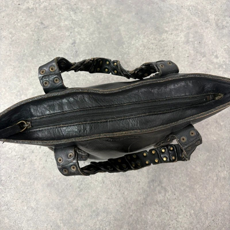 Black mini handbag with studded patchwork handle.