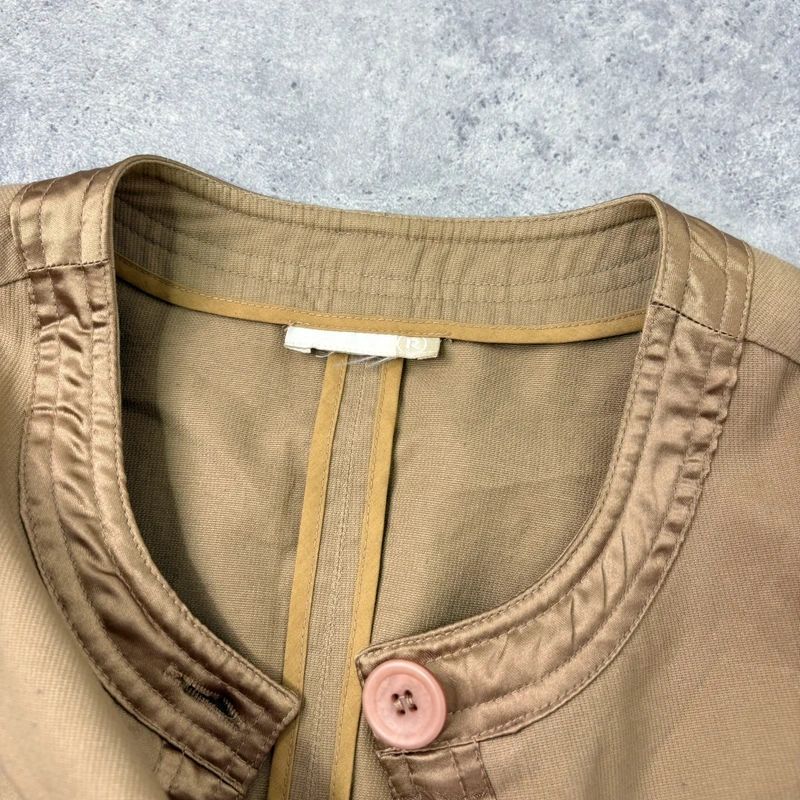 tan boxy cropped fit jacket with exposed button detail