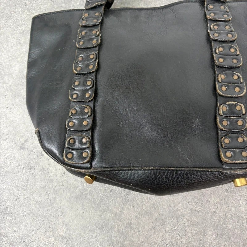Black mini handbag with studded patchwork handle.