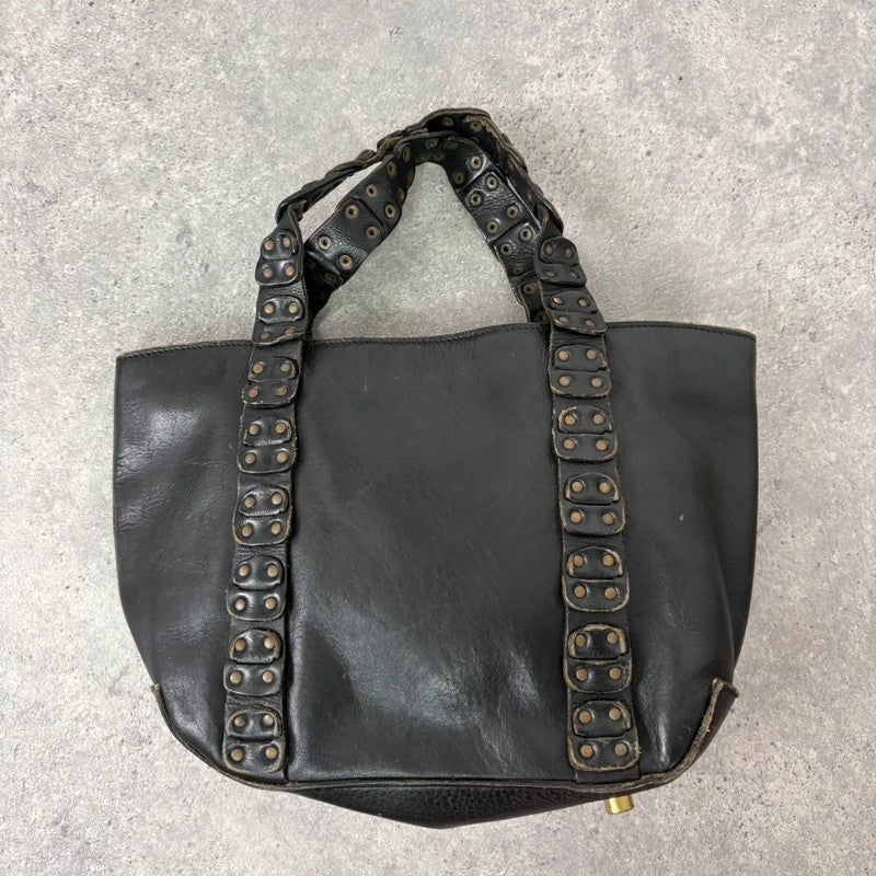 Black mini handbag with studded patchwork handle.