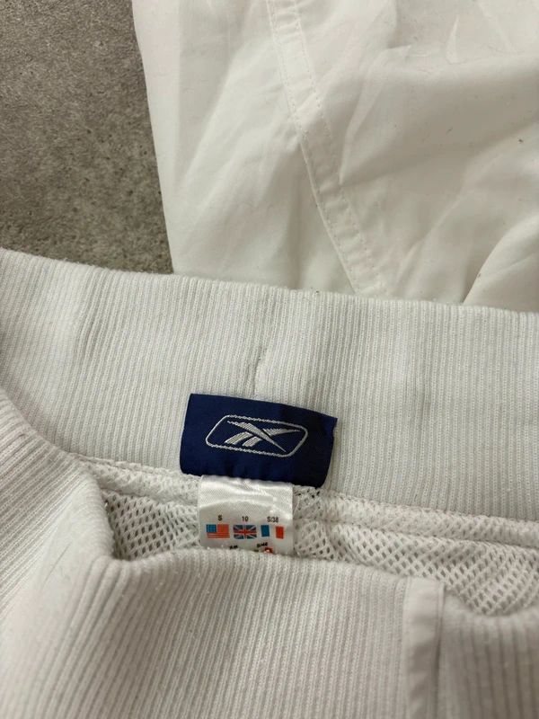 low rise white Reebok tracksuit bottoms